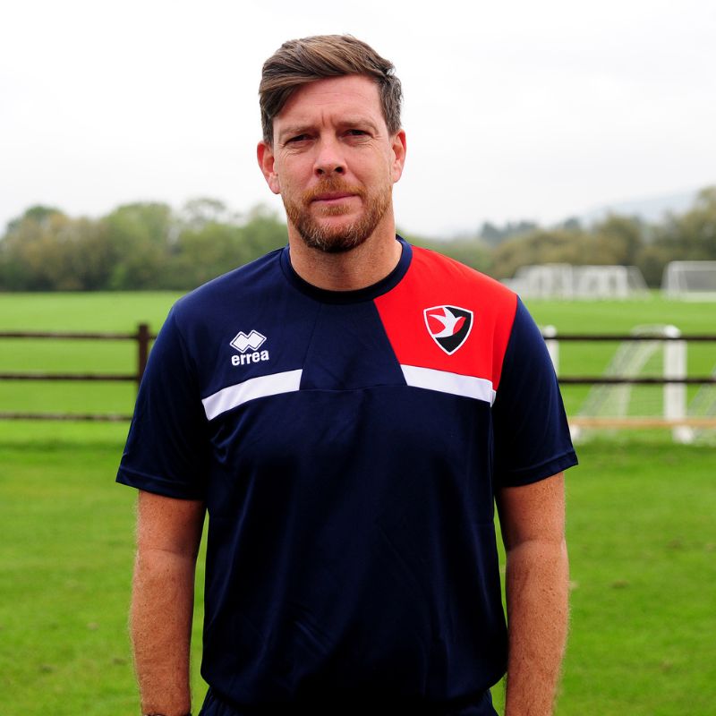 Darrell Clarke wearing Cheltenham Town FC training and managers t-shirt in blue
